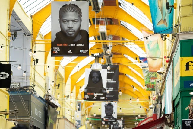 The launch of the Never Forget Stephen Lawrence exhibition, where 29 flags were installed in Brixton Village in south London ahead of National Stephen Lawrence Day (Aaron Chown/PA)